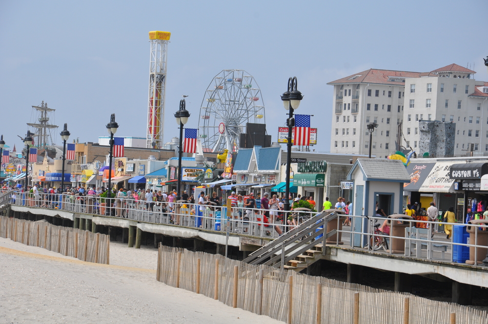 View of the Ocean City Boardwalk filled with amusement park rides.
