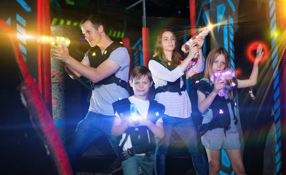 Family of four playing laser tag