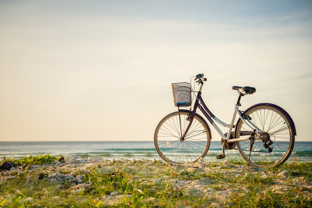 Bike standing up next to the beach