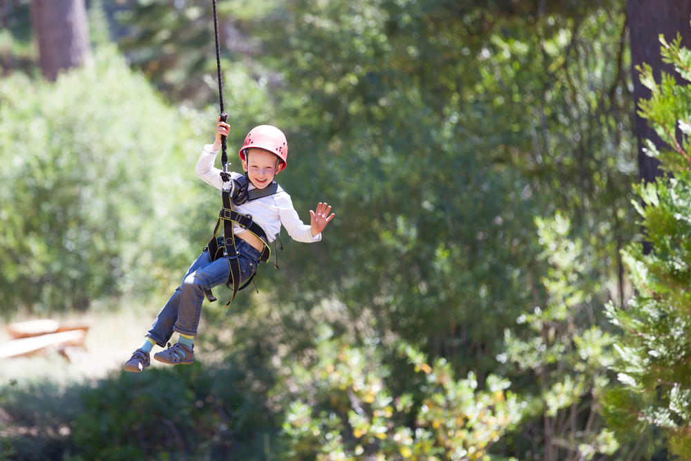 Kid smiling while ziplining