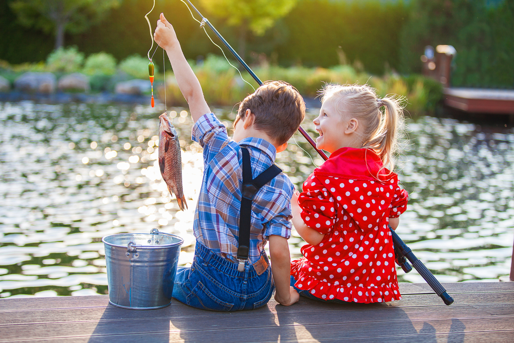 Two children fishing on a pier